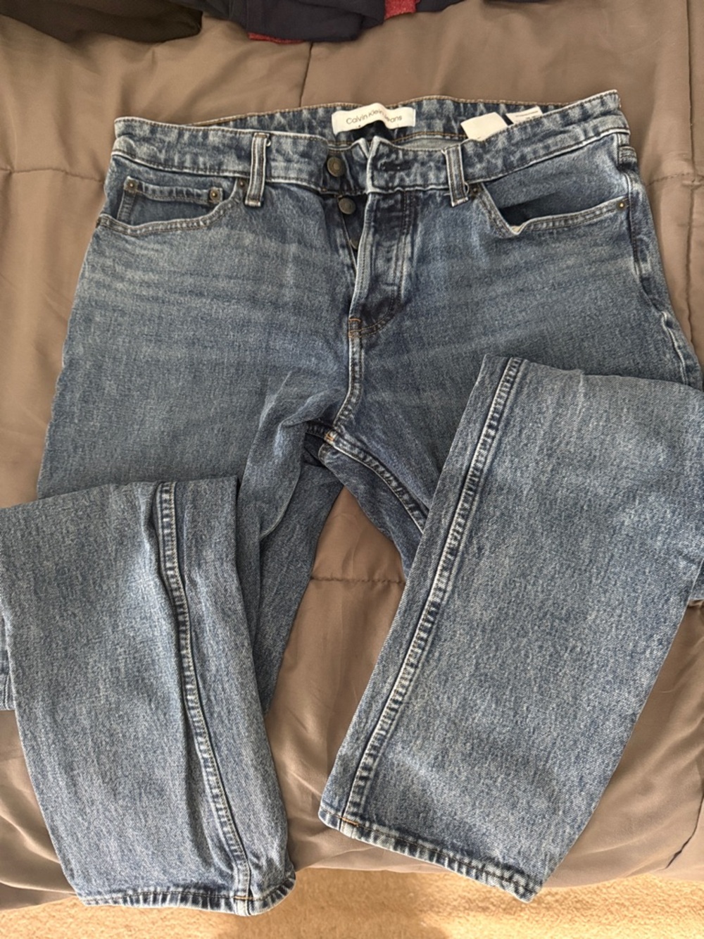 Calvin Klein Jeans blue denim button fly with a classic slim fit. Mens 34x32